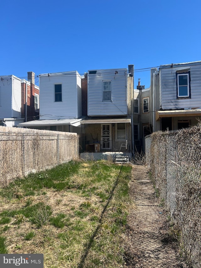 back of house featuring fence