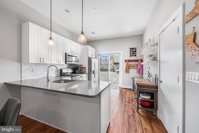 2650 E Huntingdon St, Philadelphia, PA 19125 - kitchen with white cabinets, a sink, stainless steel appliances, wood-type flooring, and backsplash