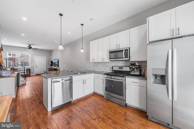 2650 E Huntingdon St, Philadelphia, PA 19125 - kitchen with a peninsula, appliances with stainless steel finishes, a sink, and white cabinets