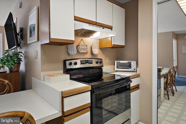 105 120th St Unit 111, Ocean City, MD 21842 - kitchen featuring light countertops, stainless steel electric range oven, light floors, under cabinet range hood, and white cabinetry