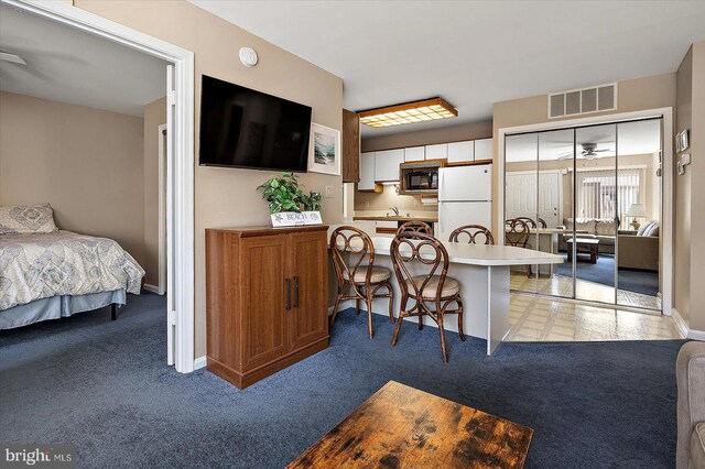 105 120th St Unit 111, Ocean City, MD 21842 - dining space featuring baseboards, ceiling fan, visible vents, and light colored carpet