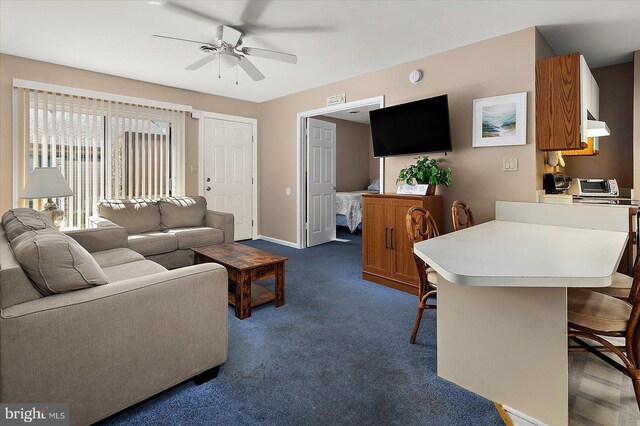 105 120th St Unit 111, Ocean City, MD 21842 - living area featuring a toaster, dark carpet, baseboards, and a ceiling fan