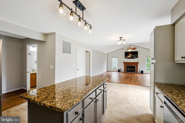 218 Foxborough Dr SW, Leesburg, VA 20175 - kitchen featuring gray cabinets, visible vents, a fireplace, stainless steel dishwasher, and a kitchen island