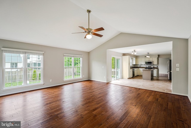 218 Foxborough Dr SW, Leesburg, VA 20175 - unfurnished living room with wood finished floors, a ceiling fan, visible vents, baseboards, and lofted ceiling