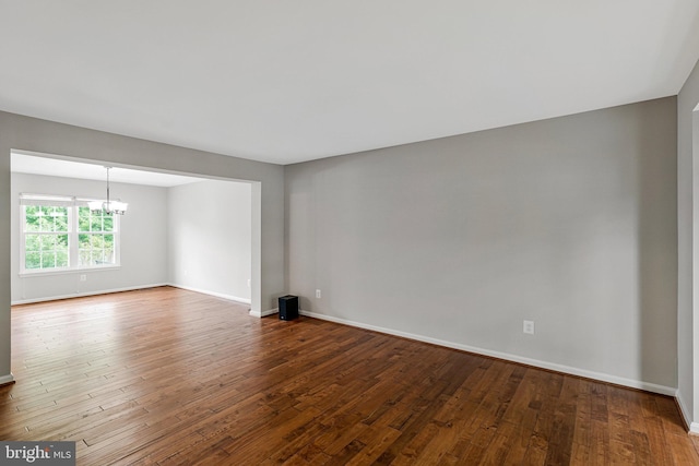 218 Foxborough Dr SW, Leesburg, VA 20175 - empty room with hardwood / wood-style flooring, baseboards, and a notable chandelier