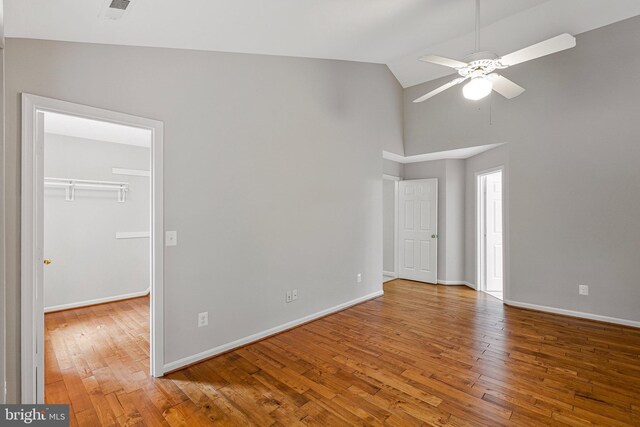 218 Foxborough Dr SW, Leesburg, VA 20175 - empty room featuring a ceiling fan, baseboards, high vaulted ceiling, and wood finished floors