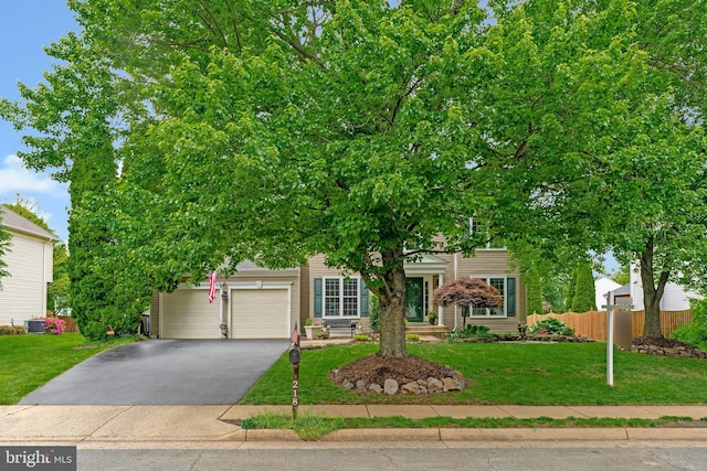 218 Foxborough Dr SW, Leesburg, VA 20175 - obstructed view of property with a garage, driveway, fence, and a front yard