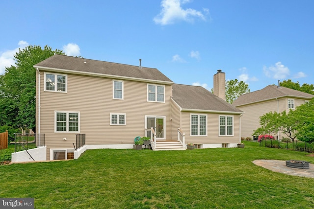 218 Foxborough Dr SW, Leesburg, VA 20175 - rear view of house featuring a yard, a chimney, a fire pit, and fence