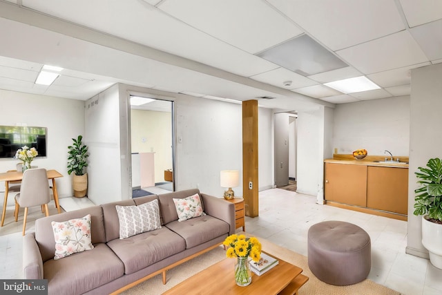 living room featuring a paneled ceiling