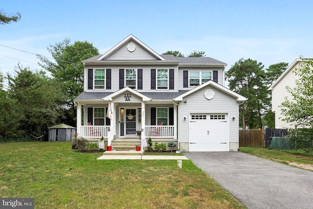 view of front of house with a front lawn, covered porch, fence, a garage, and aphalt driveway