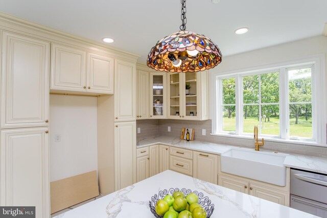 1948 Forest Grove Rd, Furlong, PA 18925 - kitchen with a sink, light stone counters, glass insert cabinets, backsplash, and recessed lighting