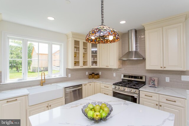 1948 Forest Grove Rd, Furlong, PA 18925 - kitchen with wall chimney range hood, appliances with stainless steel finishes, a sink, cream cabinetry, and recessed lighting