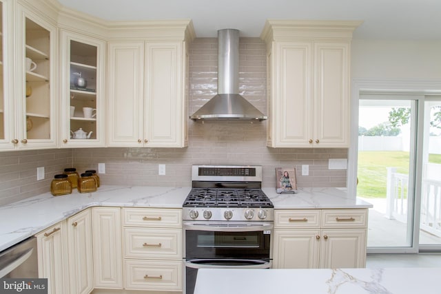1948 Forest Grove Rd, Furlong, PA 18925 - kitchen with wall chimney exhaust hood, stainless steel gas stove, decorative backsplash, and cream cabinetry