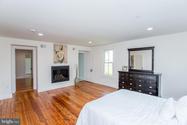 1948 Forest Grove Rd, Furlong, PA 18925 - bedroom featuring hardwood / wood-style floors, a glass covered fireplace, recessed lighting, and baseboards