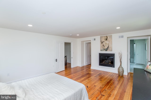 1948 Forest Grove Rd, Furlong, PA 18925 - bedroom featuring a glass covered fireplace, recessed lighting, light wood-type flooring, and baseboards