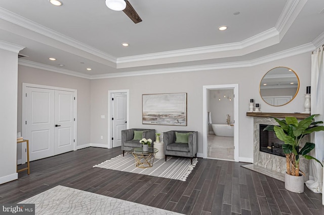 1032 Terrace Gln, Baltimore, MD 21210 - living area featuring a tray ceiling, wood finished floors, baseboards, crown molding, and a premium fireplace