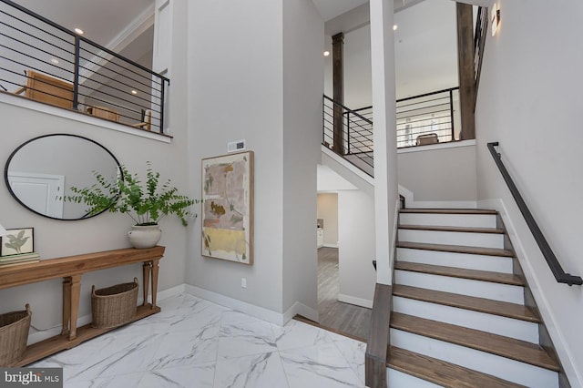 1032 Terrace Gln, Baltimore, MD 21210 - stairway with marble look tile flooring, a high ceiling, and baseboards
