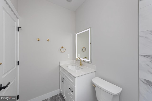 1032 Terrace Gln, Baltimore, MD 21210 - bathroom with vanity, marble look tiles, baseboards, and toilet