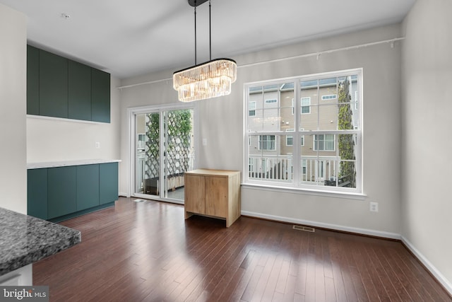 5957 Whelan Ln, Frederick, MD 21703 - unfurnished dining area with a chandelier, dark wood-style flooring, and baseboards