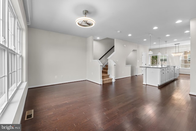 5957 Whelan Ln, Frederick, MD 21703 - unfurnished living room featuring dark wood finished floors, stairs, recessed lighting, and a sink