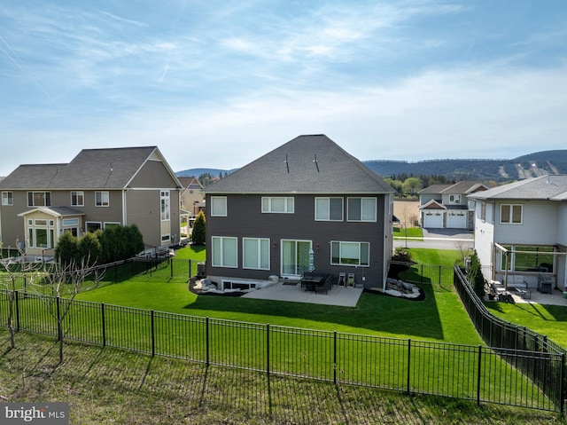 back of property with a residential view, a patio, a yard, and a fenced backyard