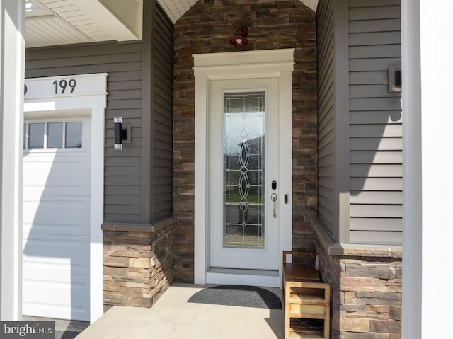 property entrance with stone siding