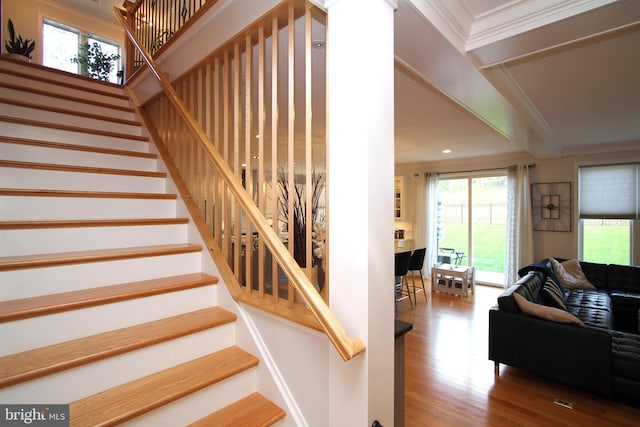 stairs featuring recessed lighting, ornamental molding, and wood finished floors
