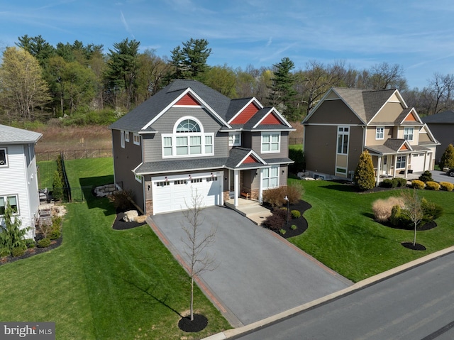 craftsman-style house featuring a garage, driveway, and a front yard