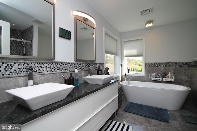 full bathroom with visible vents and a sink