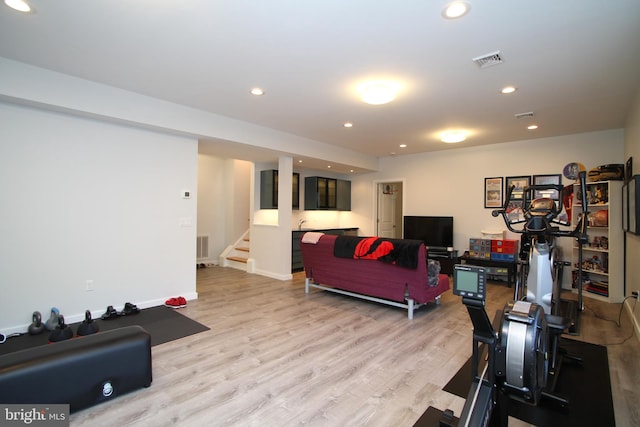 living area featuring stairway, recessed lighting, light wood-type flooring, and visible vents