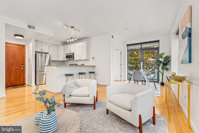 2412 17th St NW Unit 102, Washington, DC 20009 - living room with light wood-type flooring and baseboards
