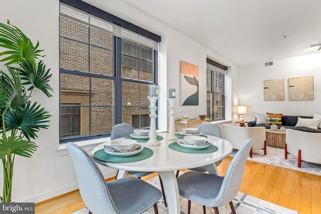 2412 17th St NW Unit 102, Washington, DC 20009 - dining area featuring wood-type flooring and baseboards