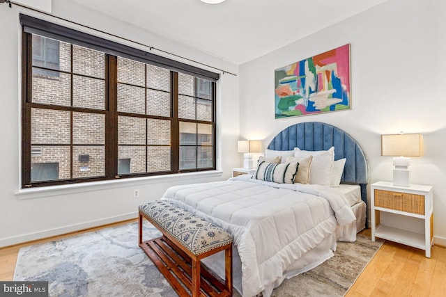 2412 17th St NW Unit 102, Washington, DC 20009 - bedroom with light wood-style floors and baseboards