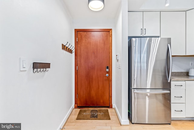 2412 17th St NW Unit 102, Washington, DC 20009 - entryway with light wood-style flooring and baseboards