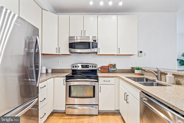 2412 17th St NW Unit 102, Washington, DC 20009 - kitchen featuring stainless steel appliances, a sink, and white cabinets