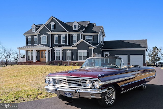 view of front facade with a front lawn, a garage, and brick siding