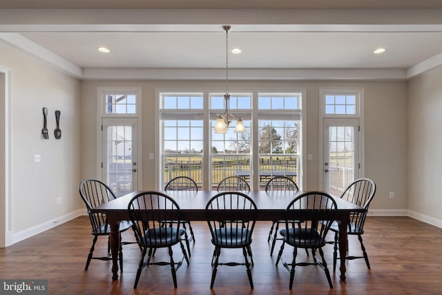 dining area with plenty of natural light, dark wood-type flooring, and baseboards