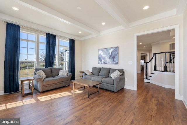 living area featuring stairway, baseboards, beamed ceiling, recessed lighting, and hardwood / wood-style floors