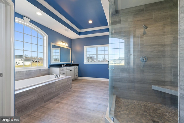 full bath with plenty of natural light, a stall shower, and vanity