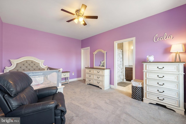 carpeted bedroom featuring baseboards, ceiling fan, and ensuite bathroom