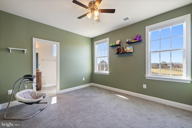 unfurnished room featuring baseboards, visible vents, carpet flooring, and a ceiling fan