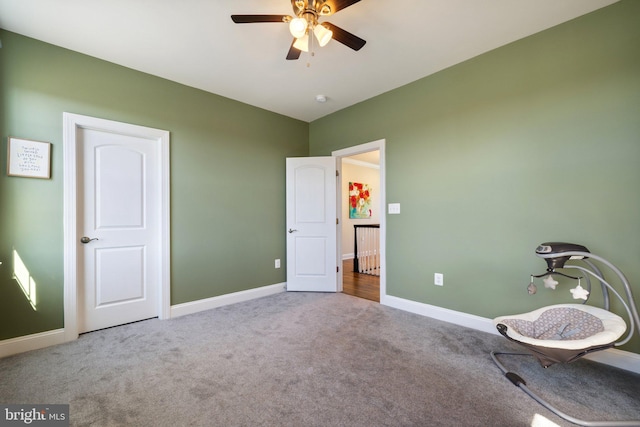 unfurnished room featuring baseboards, carpet flooring, and ceiling fan