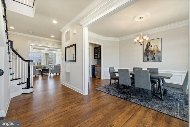 dining room with stairs, dark wood-style flooring, visible vents, ornamental molding, and an inviting chandelier