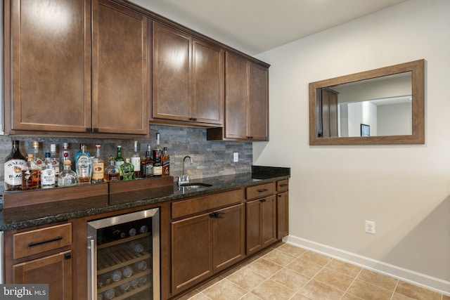 bar featuring indoor bar, a sink, beverage cooler, backsplash, and light tile patterned floors