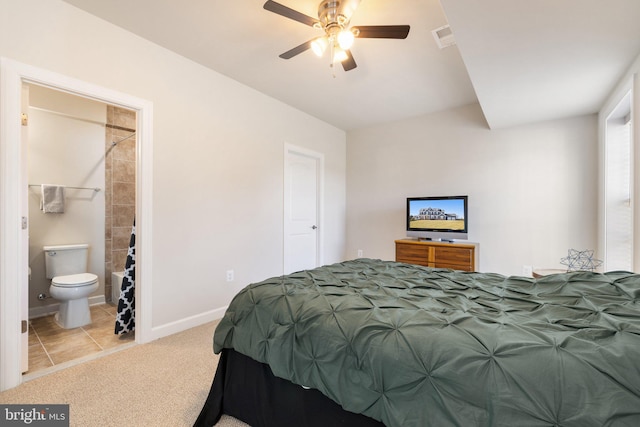 carpeted bedroom with connected bathroom, baseboards, and visible vents