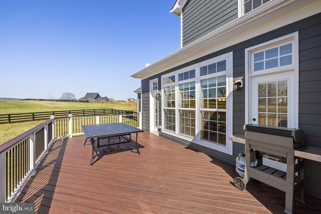 deck featuring fence and a rural view