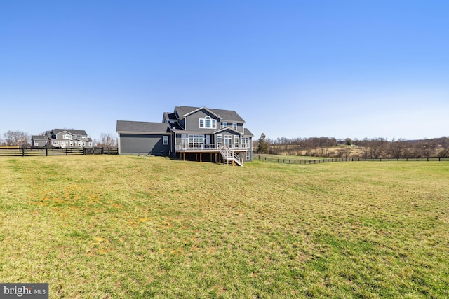 rear view of house featuring a lawn, stairs, fence, and a wooden deck