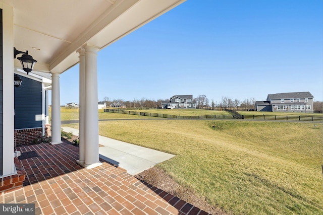 view of patio / terrace featuring fence and a rural view