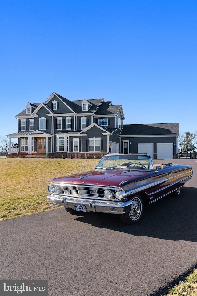 view of front of house featuring a garage and a front lawn