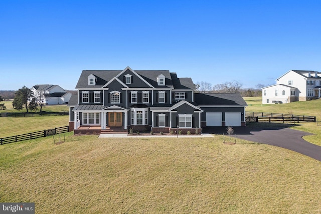view of front of home with a garage, a front yard, aphalt driveway, and fence